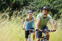 man and woman riding bikes showing how to have a healthy relationship