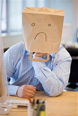 Man with bag on head obviously feeling emotional pain.